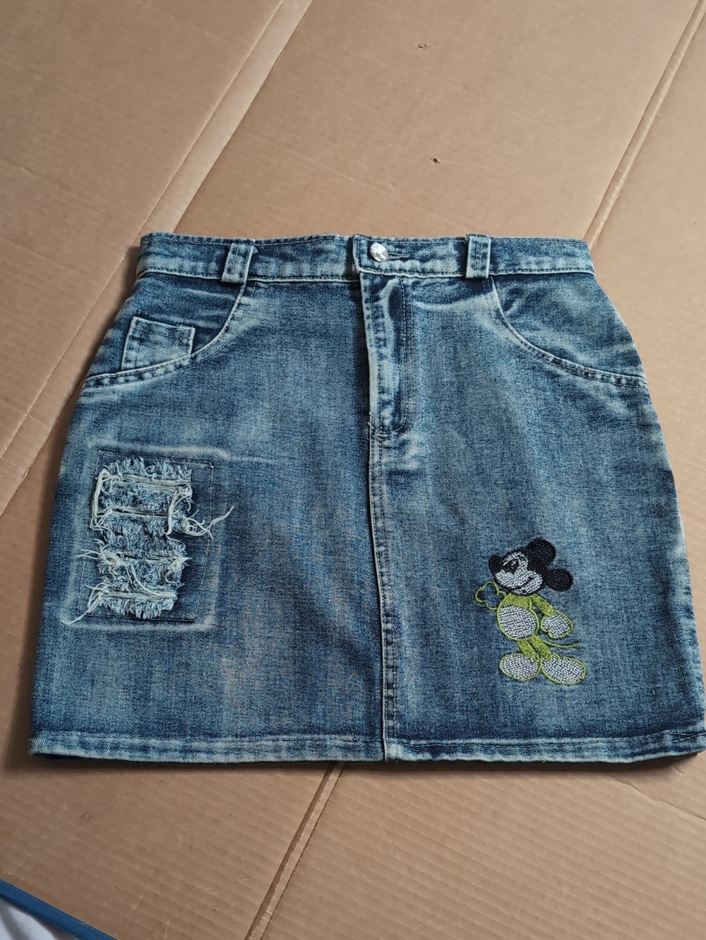 Distressed Light Wash Denim Skirt with Embroidered Graphic